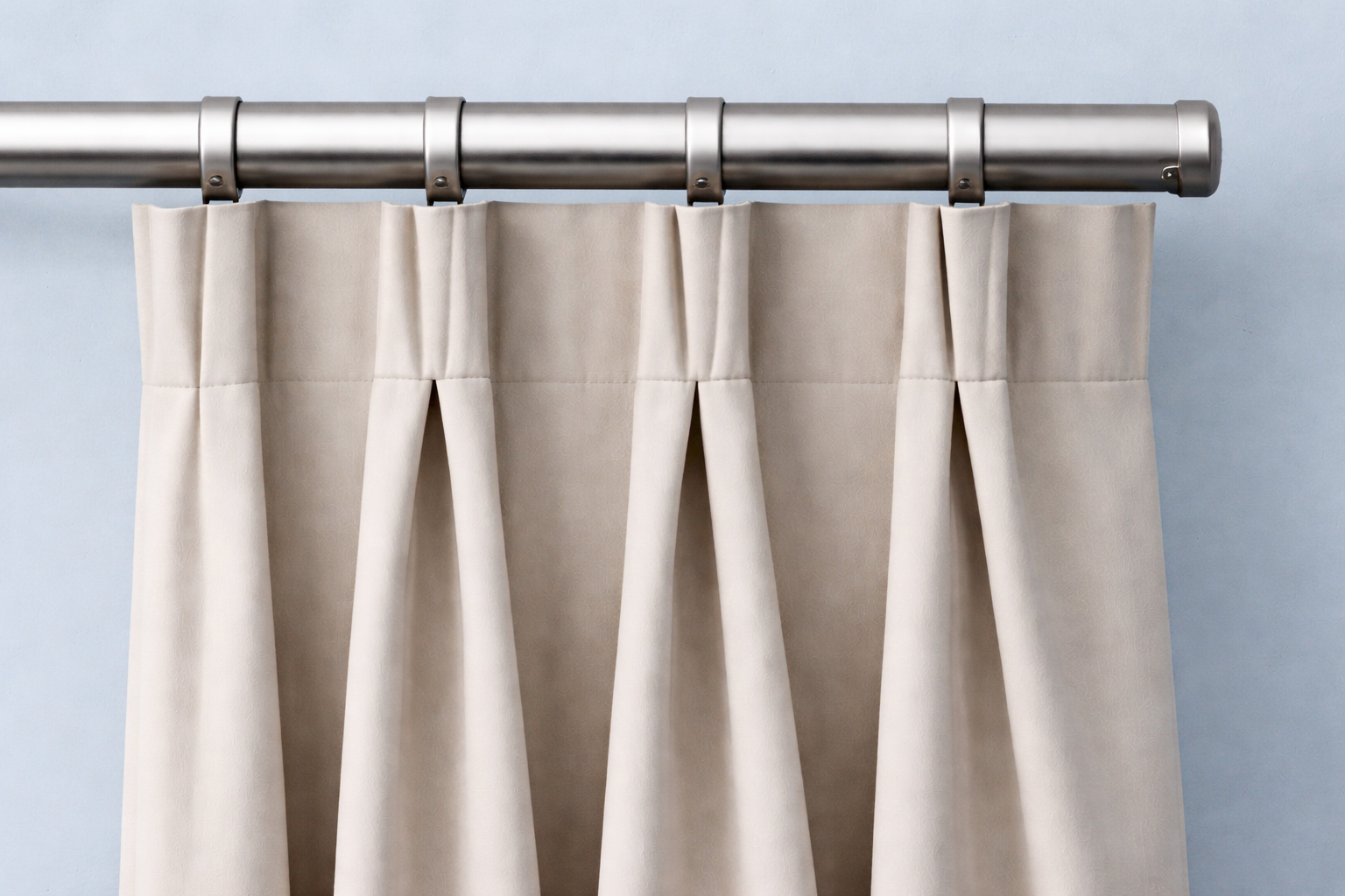 Deep, tailored pleats at regular intervals offering a structured, formal look.